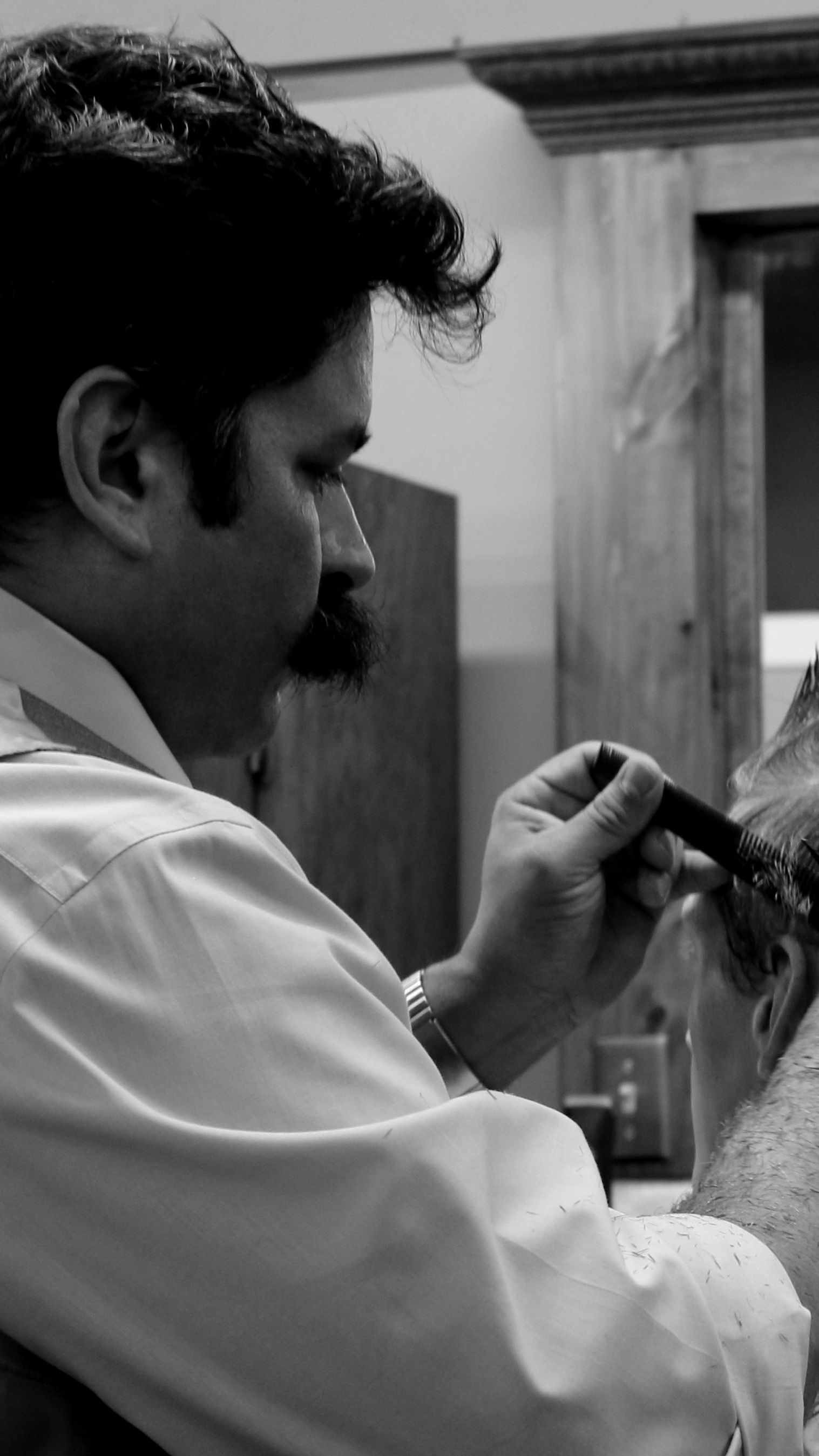 tall image of barber combing hair